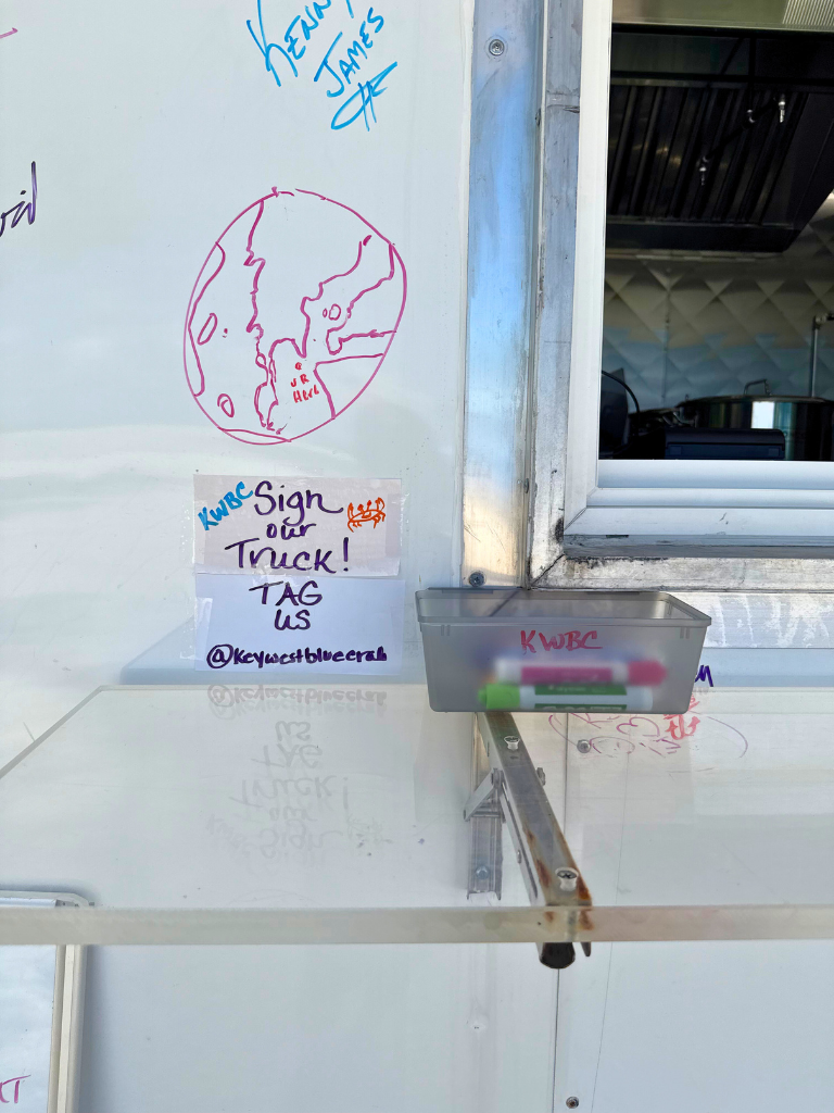 Customers signing the Key West Blue Crab food truck